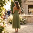 FJØRNA elegant pleated midi dress with flowy silhouette, showcasing a stylish, lightweight fabric and sophisticated design.