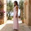 FJØRNA floral lace maxi dress with V-neck and slim fit, featuring intricate lace details and elegant flowing design.