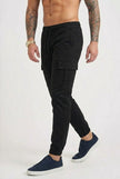 FJØRNA black cargo jogger trousers with multiple pockets, relaxed fit, and elastic cuffs, casual streetwear style.