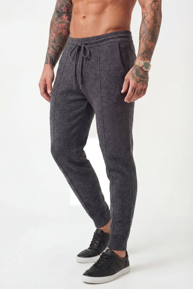 Men's dark grey merino wool trousers by FJØRNA, stylish and comfortable pants with a tailored fit and smooth fabric.