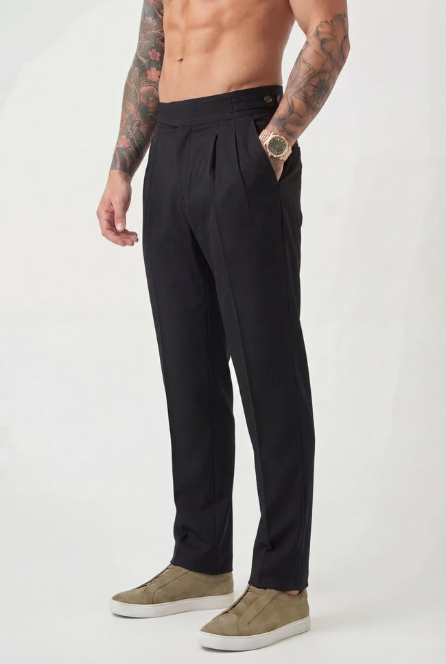 Men's tailored black trousers by FJØRNA, showing the fit and fabric detail of the stylish pants.