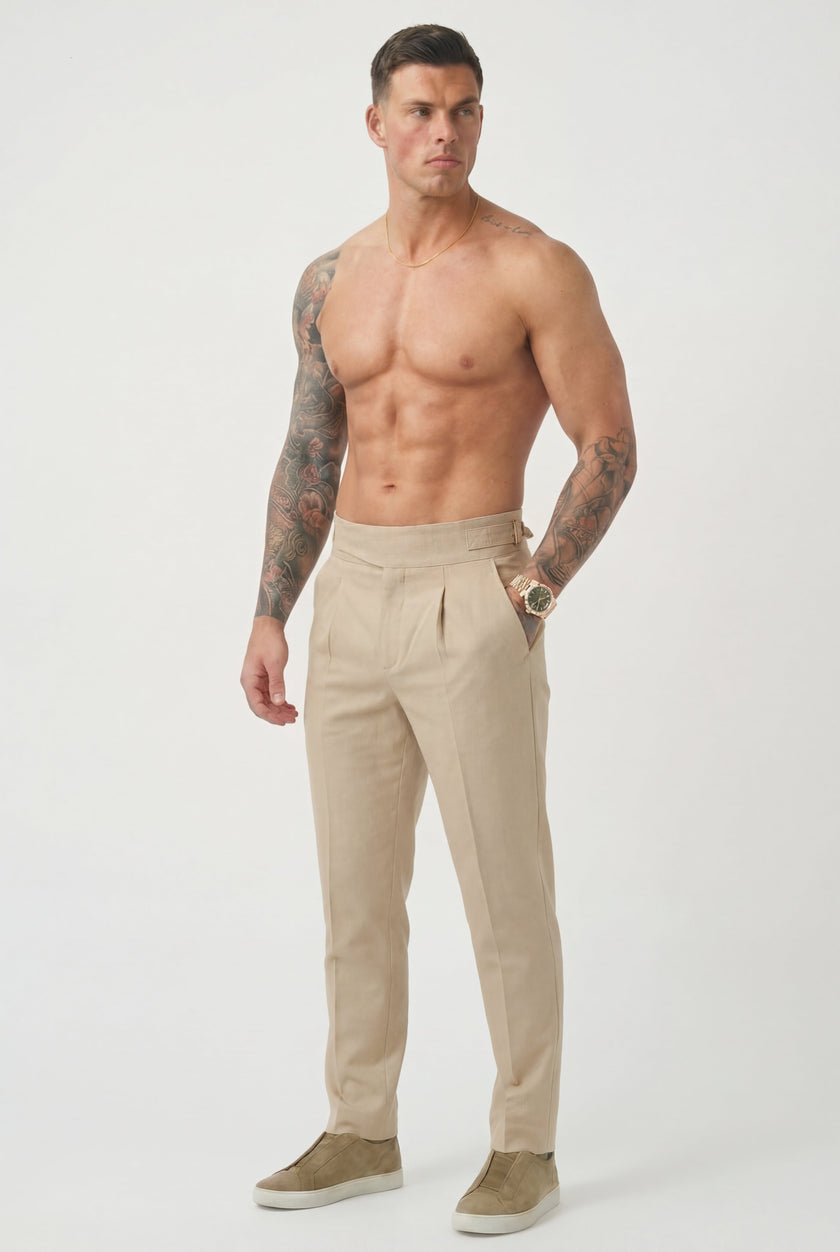 Cream tailored trousers by FJØRNA, featuring a slim fit design, visible waistband, and classic pocket details.