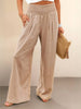 FJØRNA linen summer trousers for women with high waist, wide leg design, and drawstring detail, made of lightweight cotton and linen.