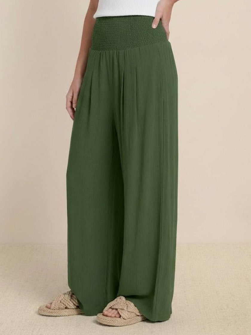 FJØRNA women's linen summer trousers with high waist and wide-leg design, featuring a drawstring for a comfortable fit.
