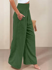 FJØRNA women's linen summer trousers with high waist and wide-leg design, featuring a drawstring for a relaxed fit.