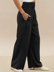 FJØRNA linen summer trousers for women with high waist, wide leg design, and drawstring waist, made of breathable cotton-linen fabric.
