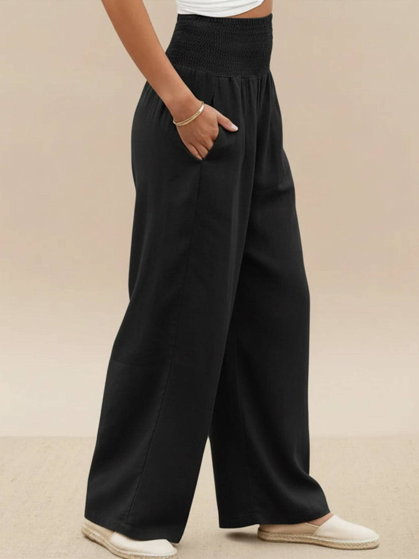 FJØRNA linen summer trousers for women with high waist, wide leg design, and drawstring waist, made of breathable cotton-linen fabric.