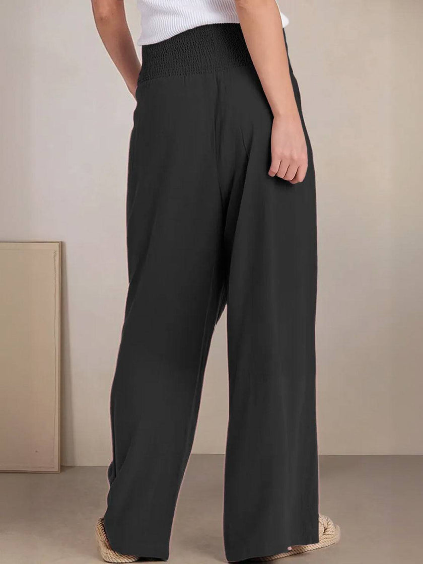 FJØRNA women’s linen summer trousers with high waist and wide-leg style, featuring a drawstring for a relaxed fit.