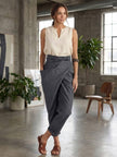 FJØRNA lightweight summer women's trousers with high waist, wide-leg fit, and pockets, shown in a wrapped, comfortable style.