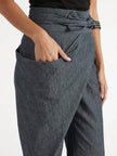 FJØRNA women's lightweight summer trousers with high waist and wide-leg design featuring front pockets on a model.