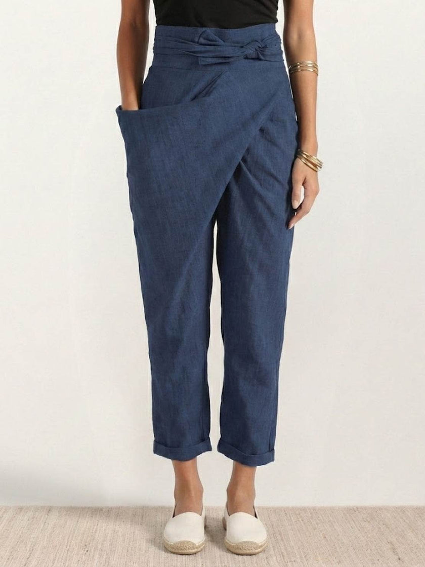 FJØRNA lightweight summer women's trousers with high waist, wide leg, and pocket details, featuring a comfortable, relaxed fit.