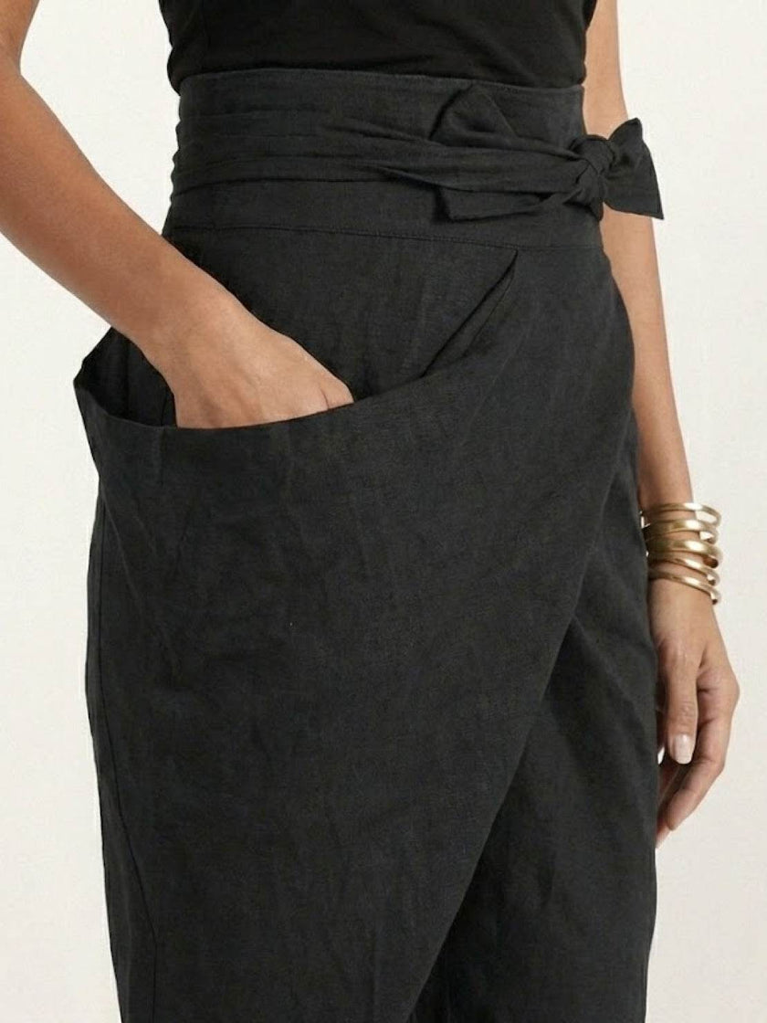 FJØRNA lightweight summer women's trousers with high waist, wide legs, and front pockets, made of comfortable, breathable fabric.