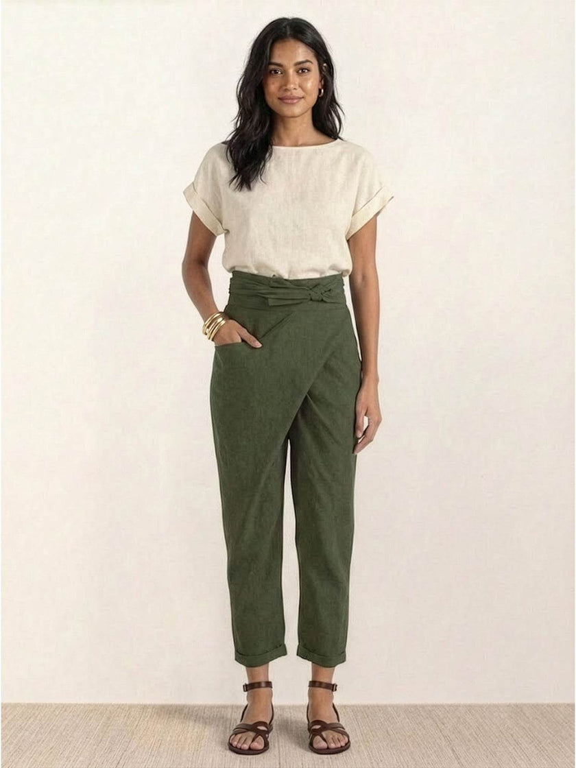 FJØRNA lightweight summer women's trousers with high waist, wide leg design, and pockets, made from comfortable fabric.