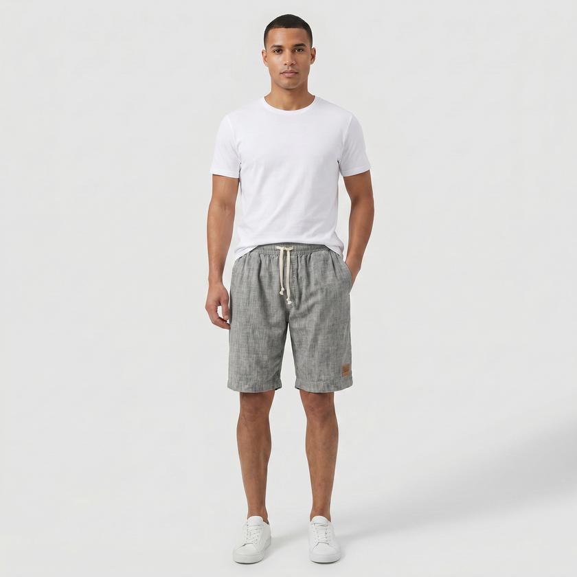 Men's linen shorts by FJØRNA with elasticated waist and drawstring, perfect for summer beachwear and casual outings.