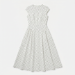 FJØRNA women's polka dot maxi dress with round neckline and A-line silhouette, flowing and stylish for elegant occasions.