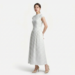 FJØRNA women's polka dot maxi dress with round neckline and A-line silhouette, flowing fabric and stylish design.