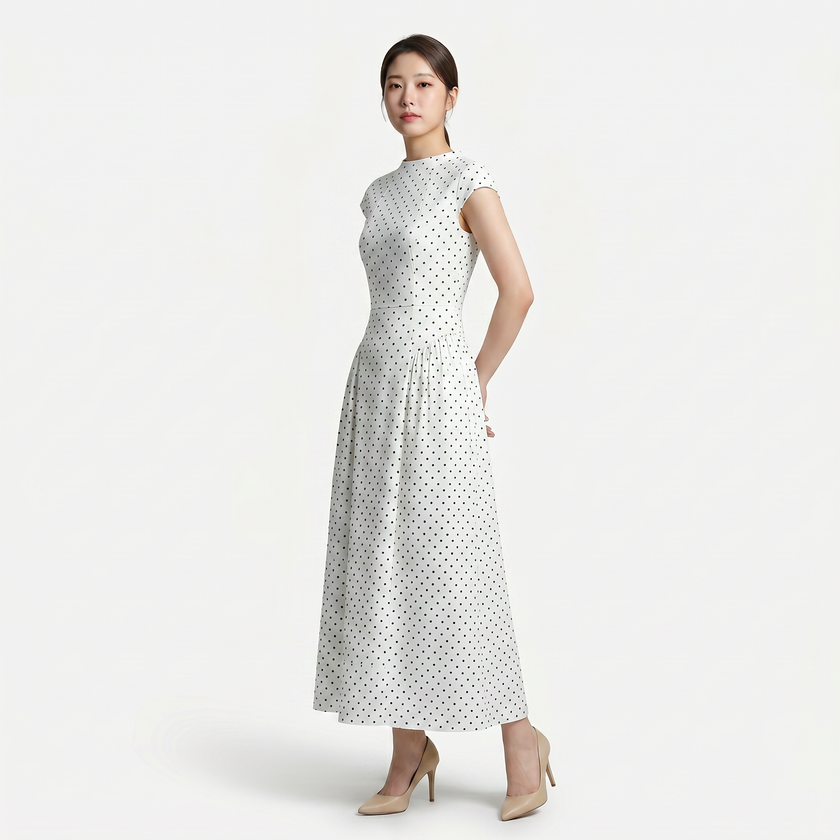 FJØRNA women's polka dot maxi dress with round neckline and A-line silhouette, flowing fabric and stylish design.