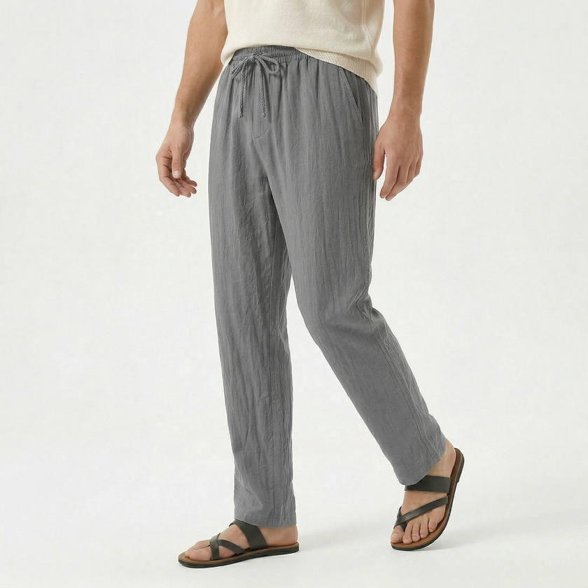 Men's linen drawstring trousers by FJØRNA, featuring lightweight fabric, relaxed fit, and adjustable waist in a neutral color.