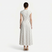 FJØRNA women's polka dot maxi dress with round neckline and A-line silhouette, flowing fabric and knee-length skirt.