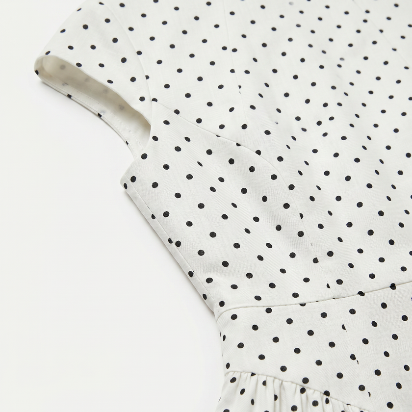 FJØRNA women's polka dot maxi dress with round neckline and A-line silhouette, flowing fabric and stylish design.