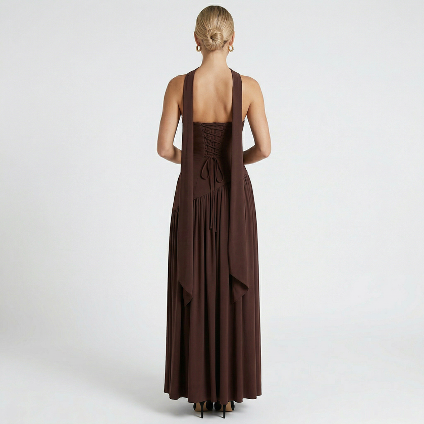 FJØRNA women's elegant strapless maxi dress showcasing a flowing fabric and fitted bodice on a model.