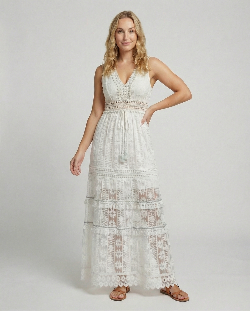 FJØRNA bohemian lace maxi dress with tiered skirt and tassel waist, featuring intricate lace details and flowing silhouette.