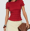 White plaid ruffle-detail women's top by FJØRNA, stylish blouse with feminine ruffles and classic plaid pattern.