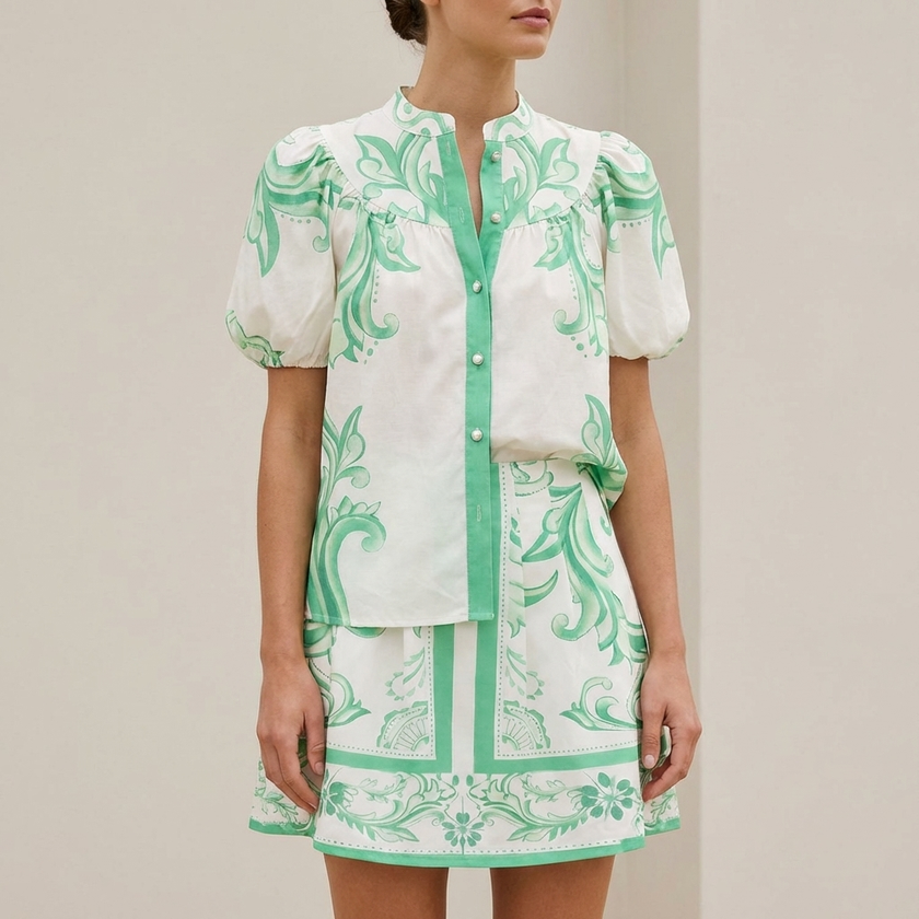 FJØRNA puff sleeve button-front top and A-line mini skirt matching set with band collar, shown on a model.