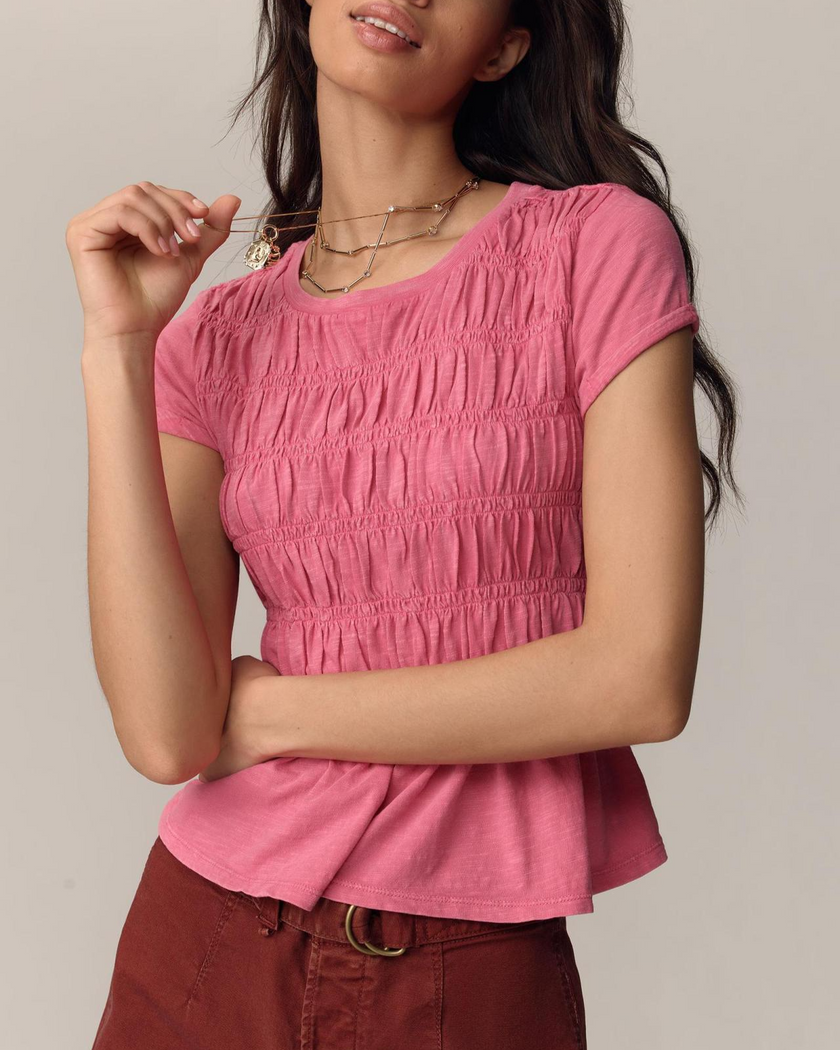 FJØRNA women's linen top with ruffle details, lightweight and stylish, featuring soft fabric and feminine design.