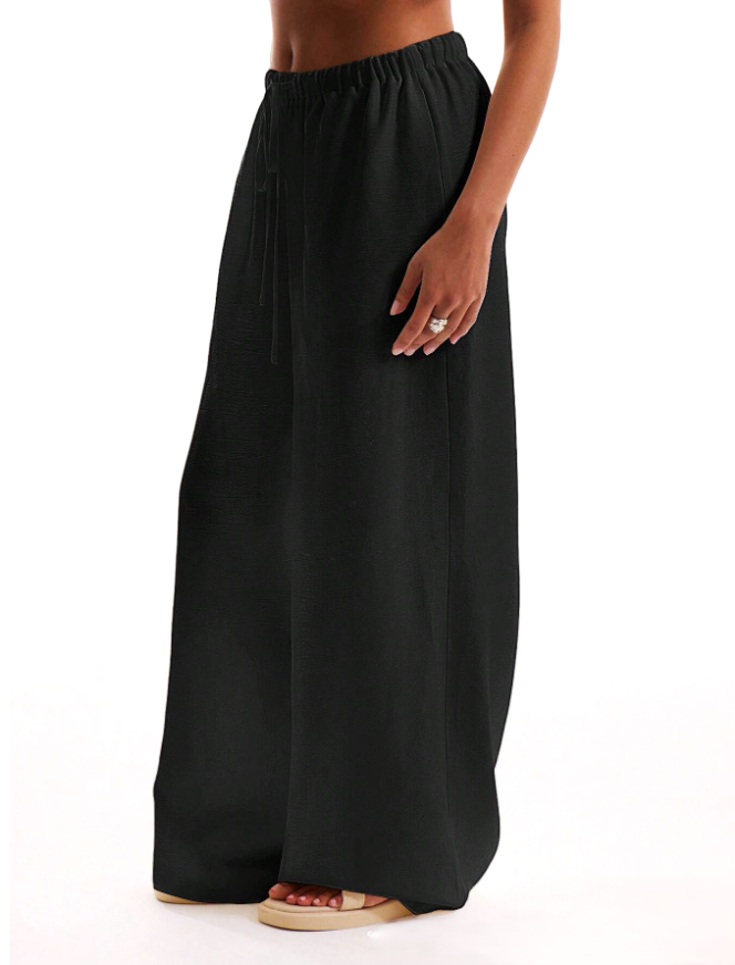 FJØRNA linen blend wide-leg women's trousers with drawstring waist, light and flowy fabric, paired with a casual top.
