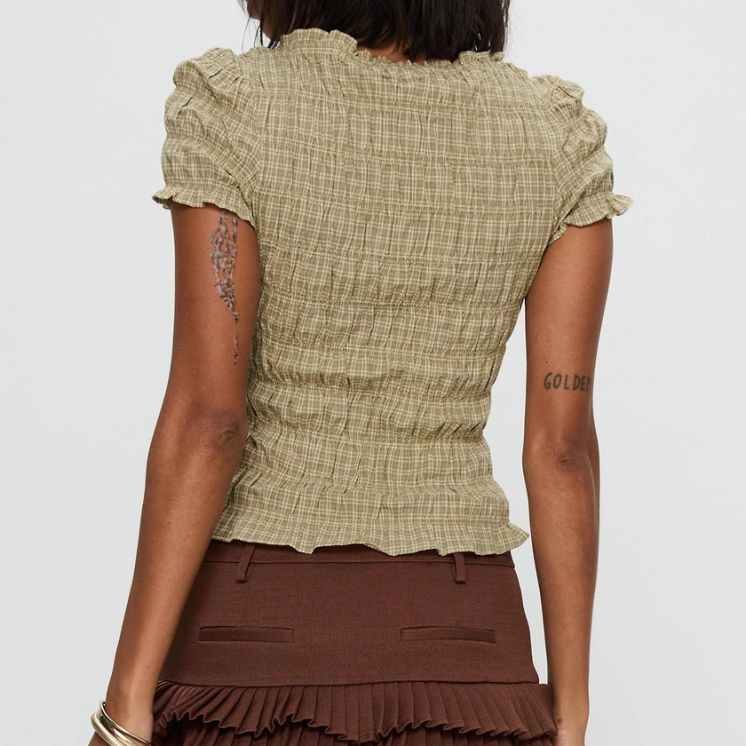Women's plaid top by FJØRNA featuring ruffle details and long sleeves, stylish casual top for women.