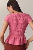 FJØRNA women's linen peplum blouse with long sleeves and a relaxed fit, featuring a stylish and breathable design.