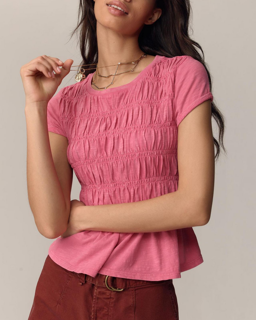 FJØRNA linen peplum blouse for women, stylish and breathable top with a flattering fit, shown in soft beige fabric.