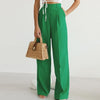 Lightweight high-waisted wide-leg pleated summer trousers for women by FJØRNA, shown in a natural fabric with a relaxed fit.