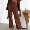 FJØRNA lightweight high-waisted wide-leg pleated summer trousers for women, shown in a natural fabric with a relaxed fit.