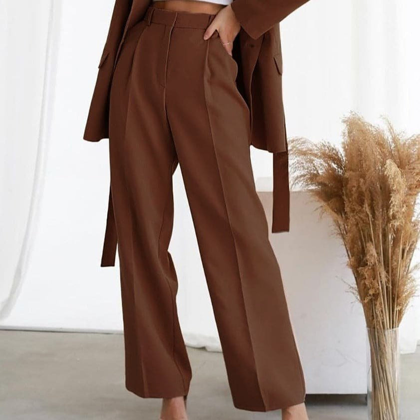FJØRNA lightweight high-waisted wide-leg pleated summer trousers for women, shown in a natural fabric with a relaxed fit.