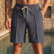 Men's relaxed knee-length tailored shorts by FJØRNA with adjustable waist and stylish seam details, shown in irongray fabric.