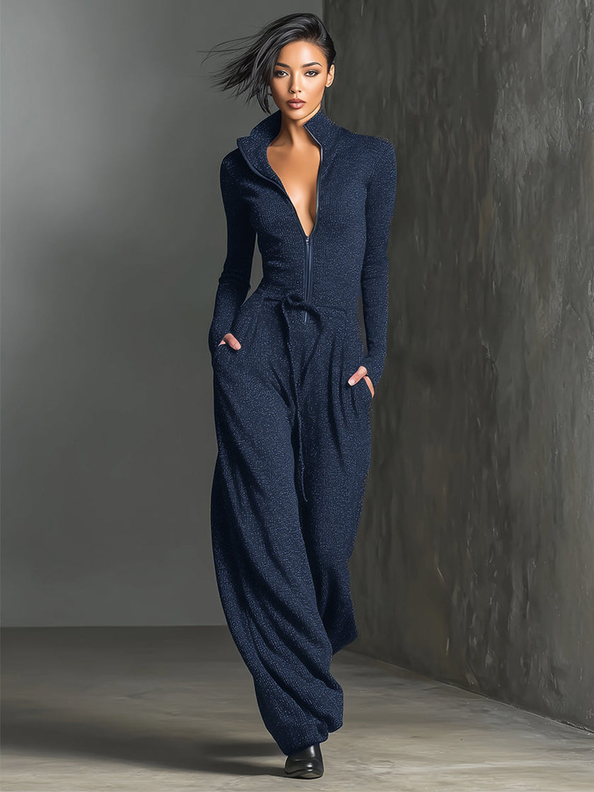 Sparkling knit women's jumpsuit by FJØRNA with zip front, long sleeves, and wide-leg pants, styled for a modern, elegant look.