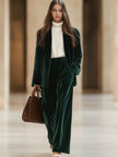Dark green vintage velvet tailored trousers with pockets by FJØRNA, showcasing a classic fit and elegant fabric texture.