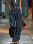 Dark blue denim FJØRNA jumpsuit with V-neck, sleeveless design and wide-leg pants, displayed on a mannequin.