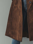 Brown vintage suede trench coat for women by FJØRNA, shown with classic lapels and belted waist on a model.