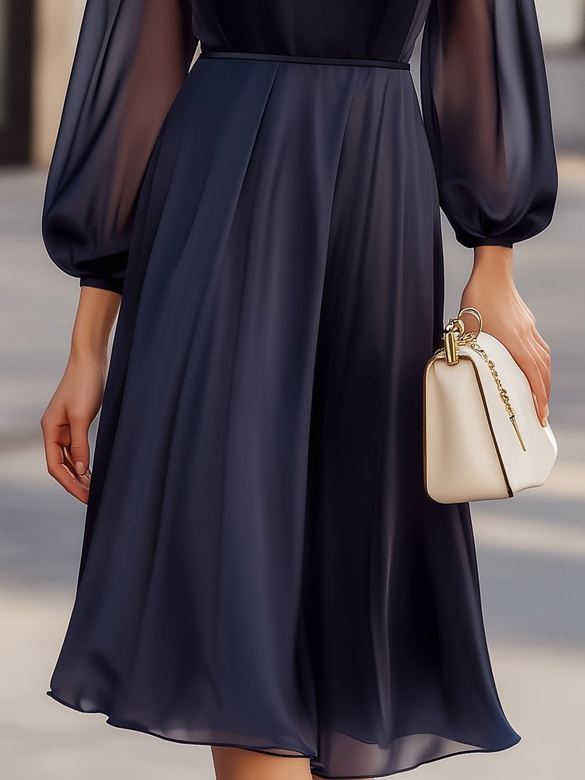 Elegant navy chiffon dress with sheer sleeves for women by FJØRNA, featuring a flowing design and sophisticated style.