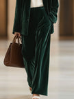 Dark green vintage velvet tailored trousers with pockets by FJØRNA, featuring a classic fit and refined design.