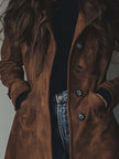 Brown vintage suede trench coat for women by FJØRNA, showing the classic double-breasted design and belted waist.