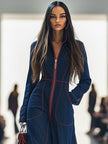 Dark blue FJØRNA denim jumpsuit with wide-leg pants and long sleeves, featuring topstitch detailing and a fitted waist.