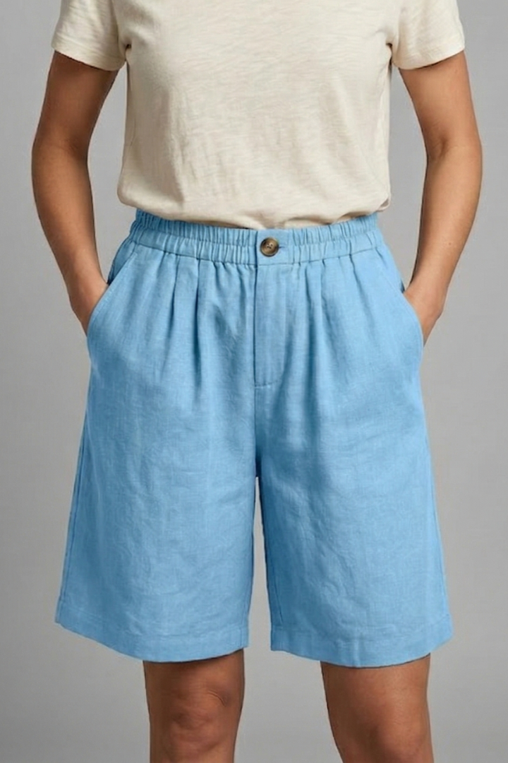 FJØRNA Juniper women's elastic waist relaxed fit shorts, beige color, soft fabric, casual style, front and side view.
