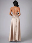 White Maxi Dress by FJØRNA with thin spaghetti straps, flowing fabric, perfect for elegant evening wear.