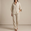 FJØRNA khaki woven two-piece relaxed shirt and wide-leg trouser set for urban leisure, displayed on a hanger.