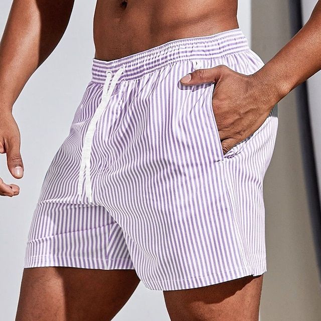 Men's casual striped boardshorts by FJØRNA with blush pink color, drawstring waist, and side slit hem for a relaxed summer look.
