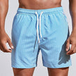 FJØRNA men's casual striped boardshorts in light blue with drawstring and side slit hem, perfect for beach or pool days.